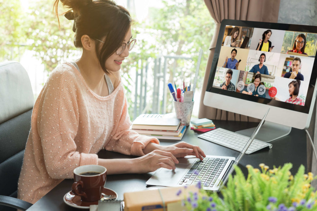 Asian woman work from home during corona virus, COVID-19 out break use laptop for teleconference with her team mates